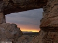 Sunset viewed through natural rock window in  Isalo National Park (Isalo)